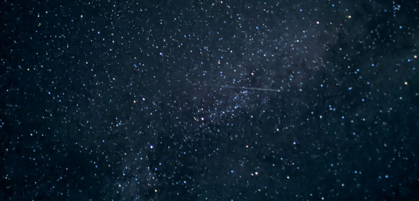 A picture of the stars in Badlands National Park, including a shooting star.
