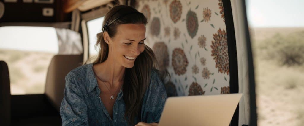 A woman looking at her laptop inside her RV