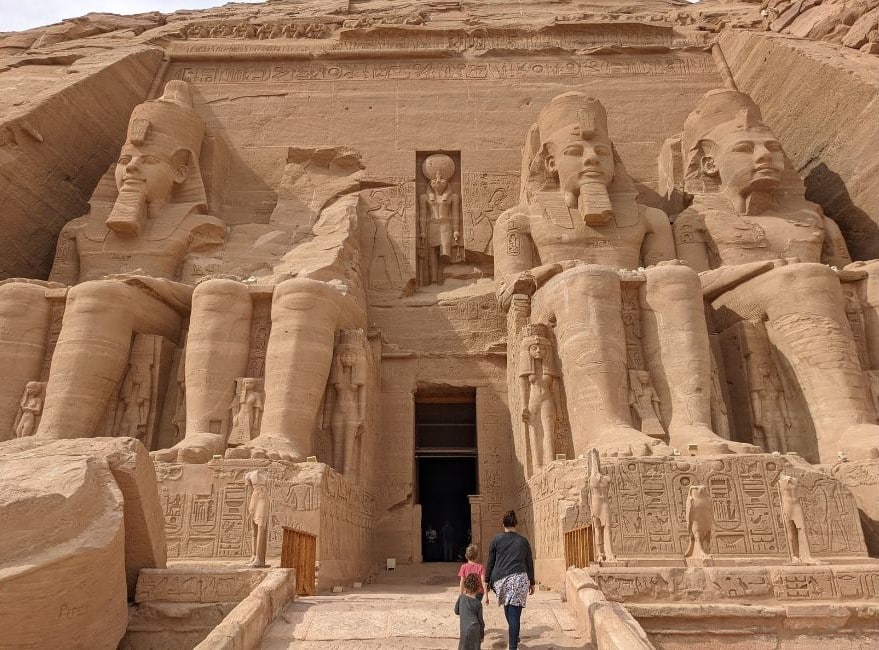 A family walks into the entrance of Abu Simbel Temple