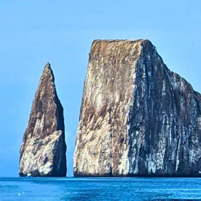 Kicker rock rising above the surrounding waters