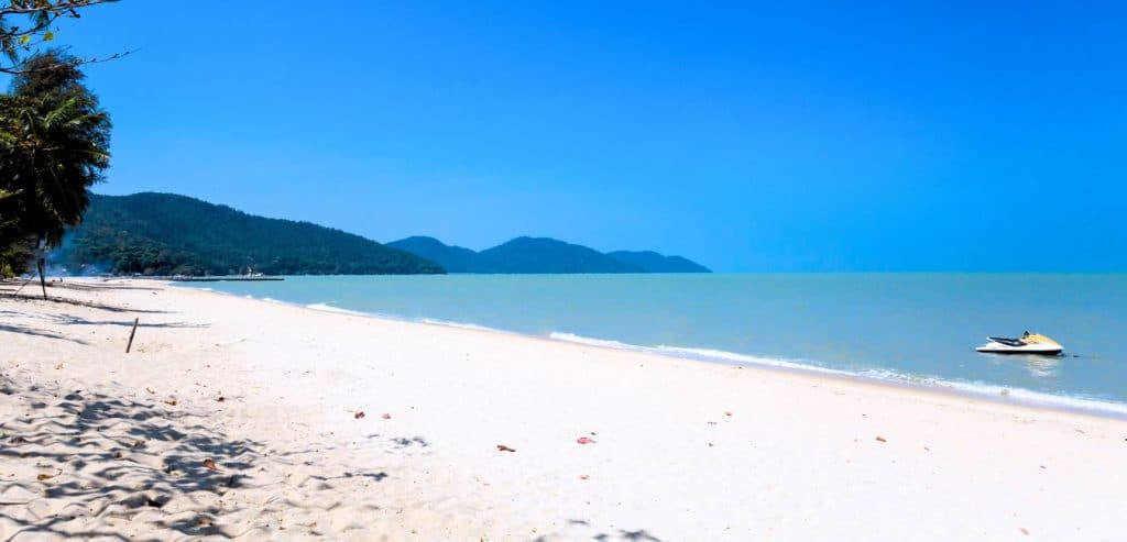 An empty stretch of white sand at Batu Ferringhi Beach.
