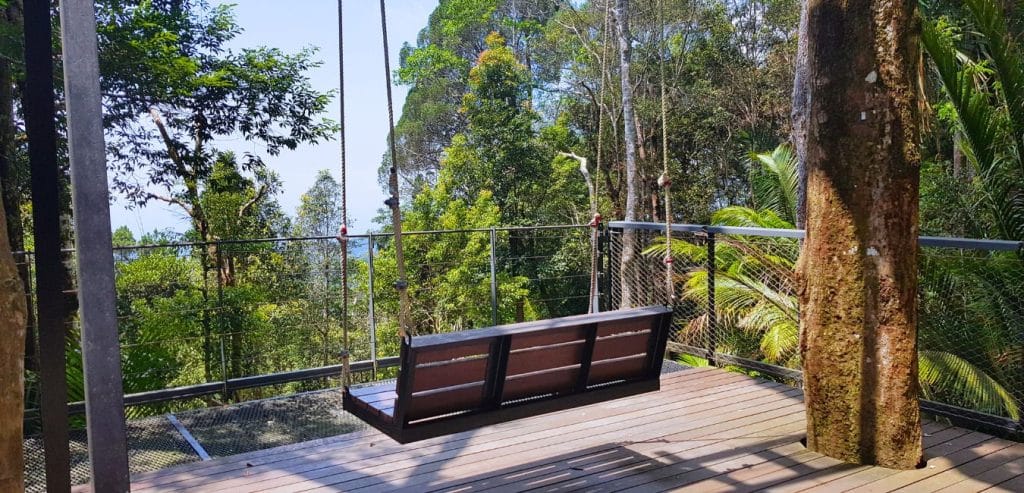 A swinging bench with a view of the jungles Penang Hill.