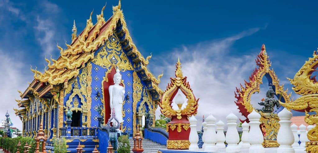 A blue temple with gold-colored decorations in Chiang Rai.