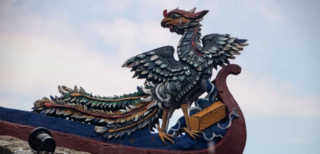 A wooden phoenix carving on the roof of the Cam Pho Communal House.