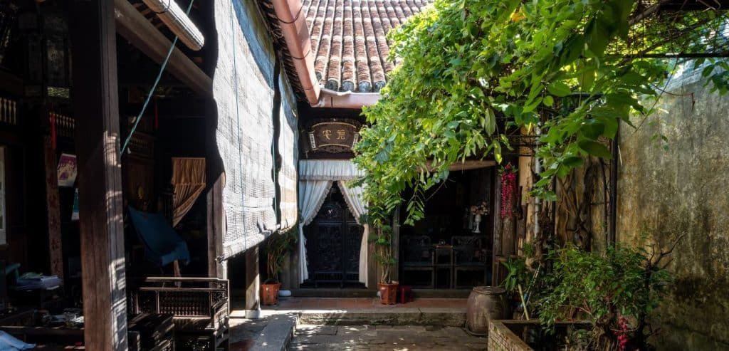 An exterior space with a tree in the Duc An House.