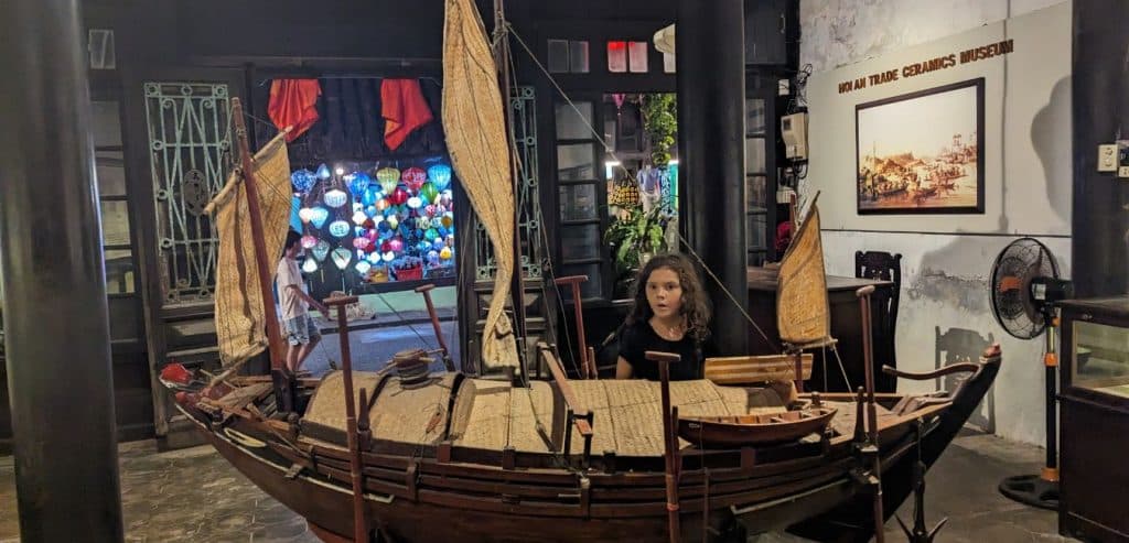 A girl looks at a model of a ship in the Trade Ceramics Museum.