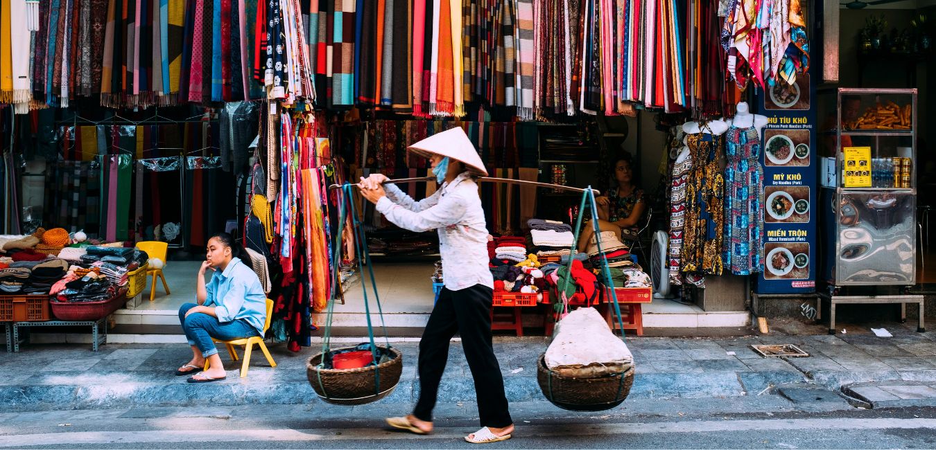 A Street Vendor walking down the street in the Old Quarter if Hanoi.