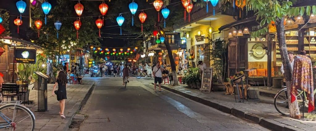 Colorful lanterns strung across a street in Hoi An at night time.
