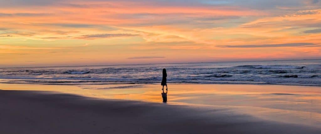 My daughter walking the beach at sunset