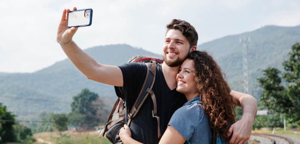 Tourists using their phone as a camera for a selfie