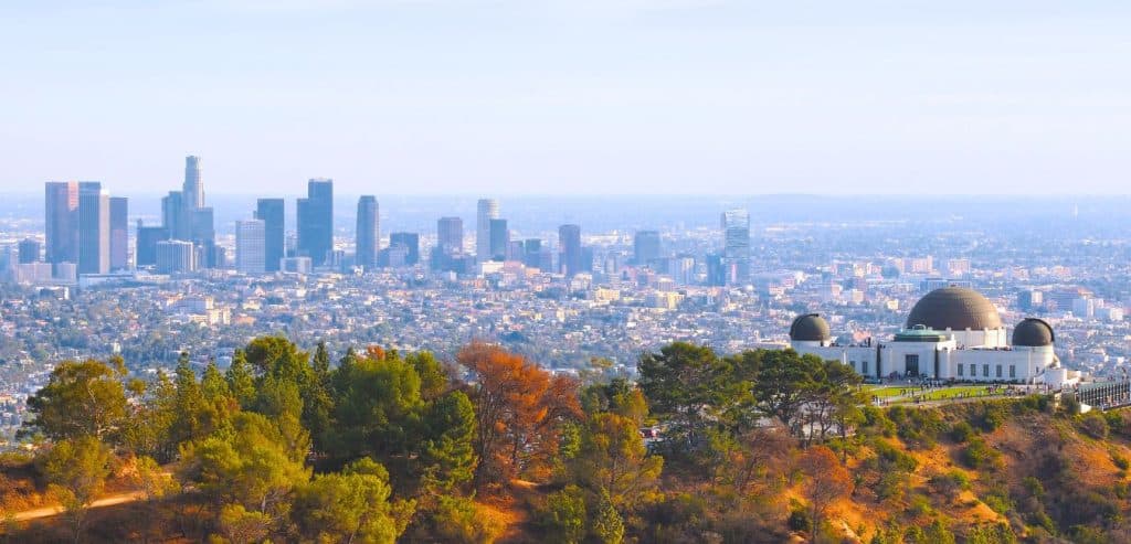 Griffith Observatory in LA with the city skyline behind it.