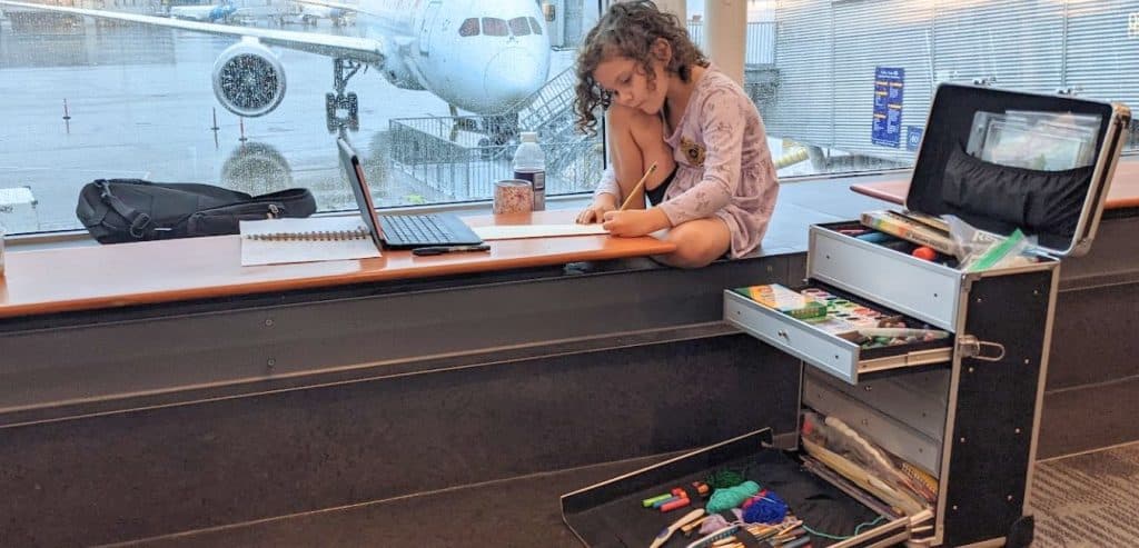 A girl doing art at the airport