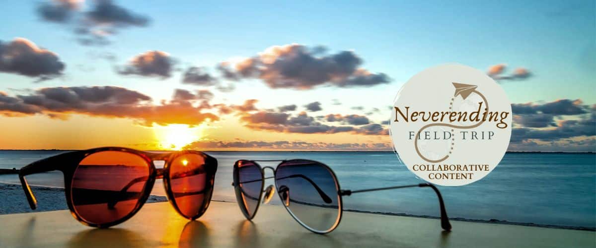 A pair of sunglasses in front of a sunset