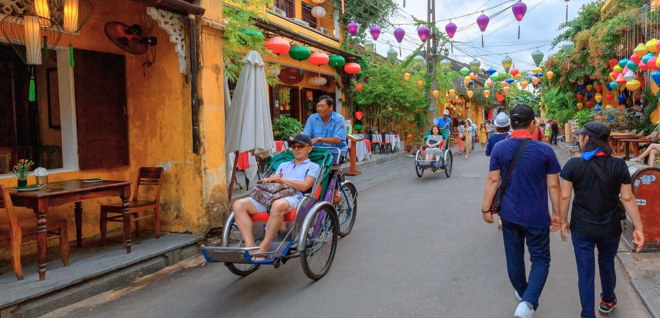 A tourist riding in a cyclo in Hoi An, Vietnam